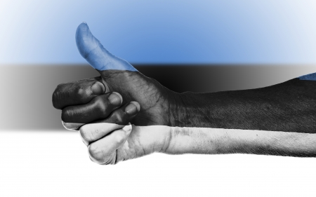 Old woman giving the thumbs up sign, isolated, flag of Estoniaの写真素材