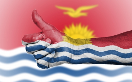 Old woman giving the thumbs up sign, isolated, flag of Kiribatiの写真素材