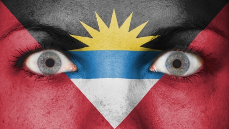 Close up of eyes. Painted face with flag of Antigua and Barbudaの写真素材