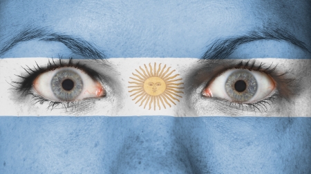 Close up of eyes. Painted face with flag of Argentinaの写真素材