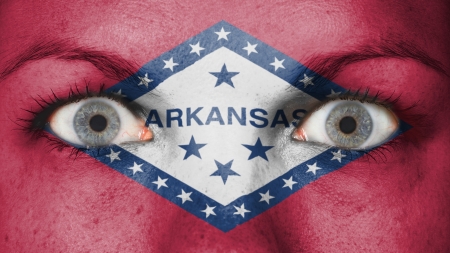 Close up of eyes. Painted face with flag of Arkansasの写真素材