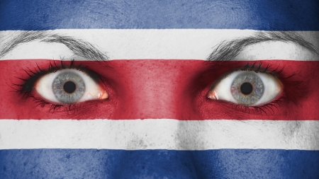 Close up of eyes. Painted face with flag of Costa Ricaの写真素材