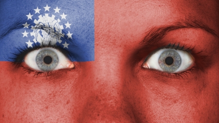 Close up of eyes. Painted face with flag of Myanmarの写真素材