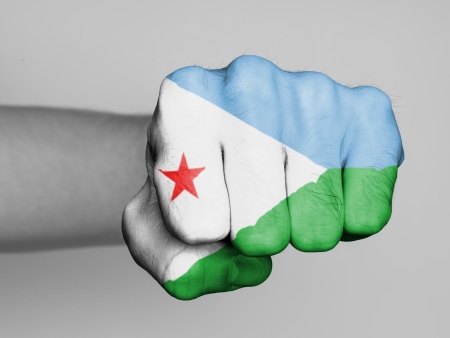 Fist of a man punching, flag of Djiboutiの写真素材