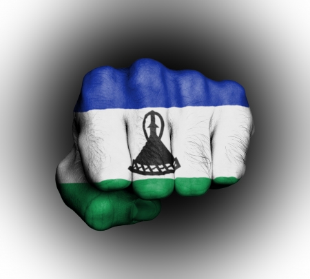 Fist of a man punching, flag of Lesothoの写真素材