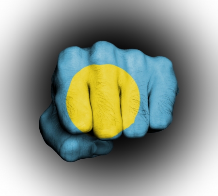 Fist of a man punching, flag of Palauの写真素材