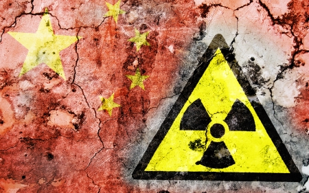 Old cracked wall with radiation warning sign and painted flag, flag of Chinaの写真素材