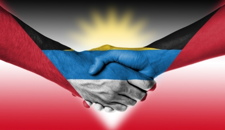 Man and woman shaking hands, wrapped in flag pattern, Antigua and Barbudaの写真素材