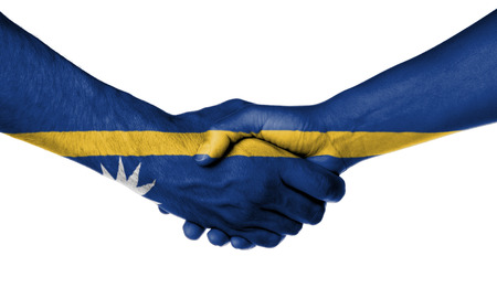 Man and woman shaking hands, wrapped in flag pattern, Nauruの写真素材