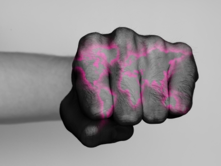 Very hairy knuckles from the fist of a man punching, world map neon print