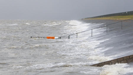 Extreme high tide at the dikes of the dutch coastal worksの写真素材