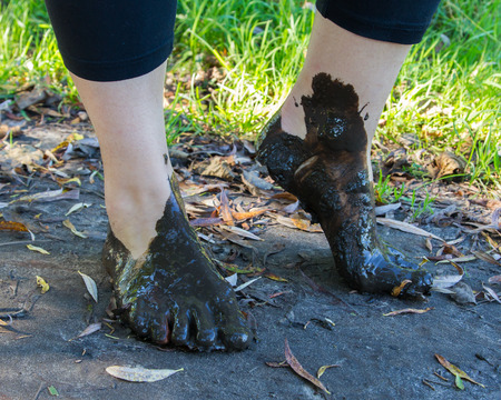 Feet in mud close-up, feet of a womanの写真素材
