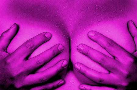 Upper part of female body, hands covering breasts, pinkの写真素材