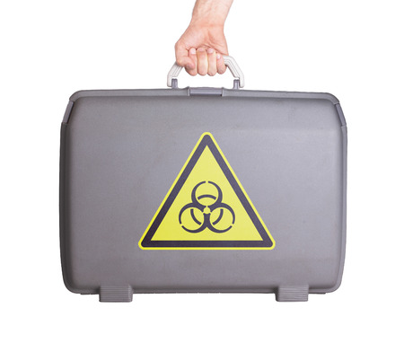 Used plastic suitcase with stains and scratches, printed with sign, danger, biohazard