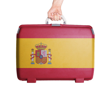 Used plastic suitcase with stains and scratches, printed with flag, Spainの写真素材