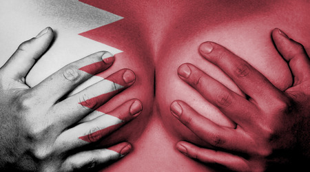 Upper part of female body, hands covering breasts, Bahrainの写真素材