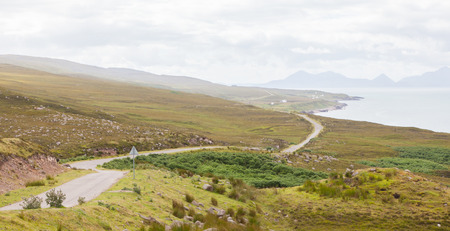 Highlands of Scotland narrow road in mountain landscapeの写真素材