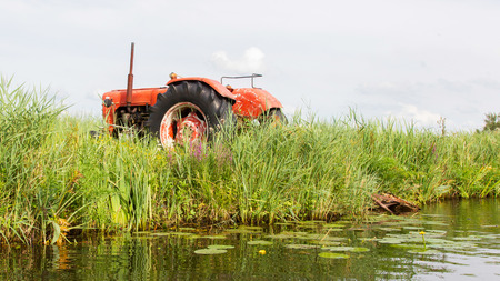 Farmers pumping water with old tractor, the Netherlandsの写真素材