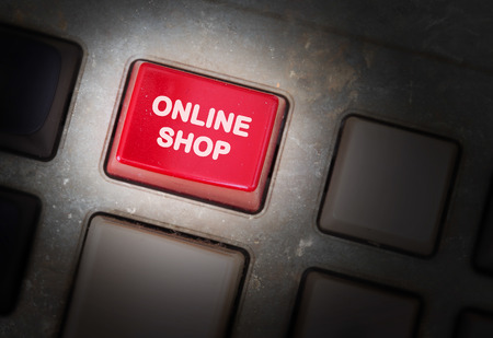 Red button on a dirty old panel, selective focus - online shopの写真素材