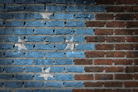 Very old dark red brick wall texture with flag - Micronesiaの写真素材