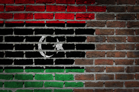 Very old dark red brick wall texture with flag - Libyaの写真素材