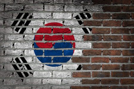 Very old dark red brick wall texture with flag - South Koreaの写真素材