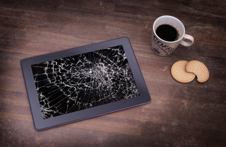 Tablet computer with broken glass, screen destroyedの写真素材