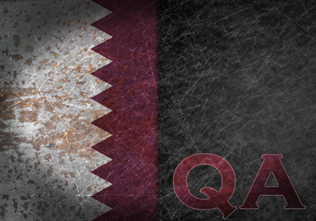 Old rusty metal sign with a flag and country abbreviation - Qatarの写真素材