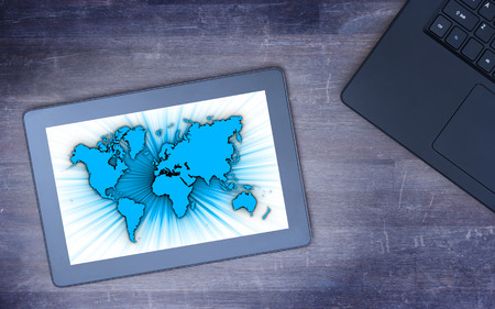 World map on a tablet, concept of globalisation, cold blue filter