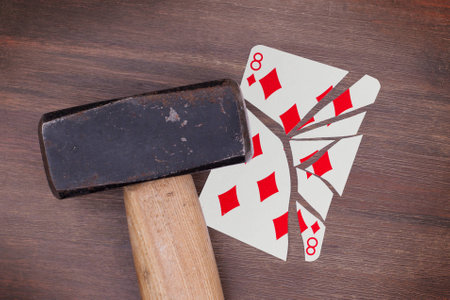 Hammer with a broken card, vintage look, eight of diamondsの写真素材