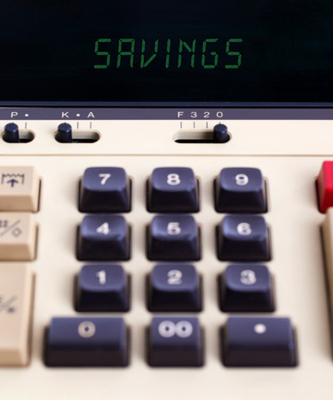 Old calculator showing a text on display - savingsの写真素材