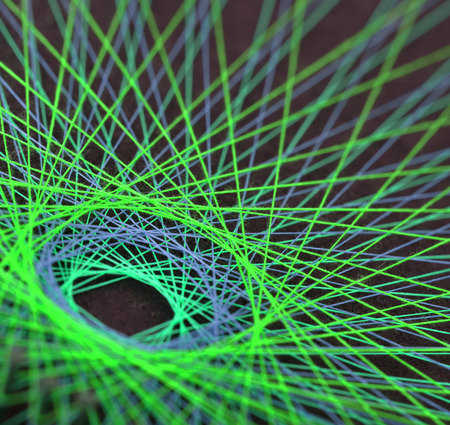 Display of colorful threads on a black panelの写真素材