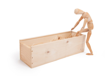 Wood figure mannequin stepping in a wooden box - concept of death or retailの写真素材