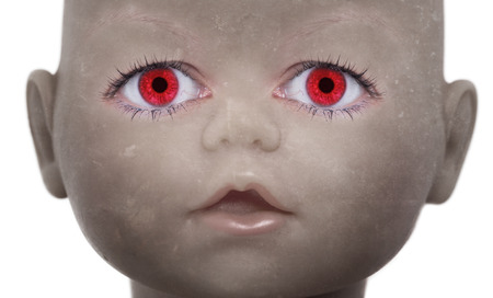 Scary doll face with human looking eyesの写真素材