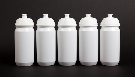 White water bottles isolated on black backgroundの写真素材