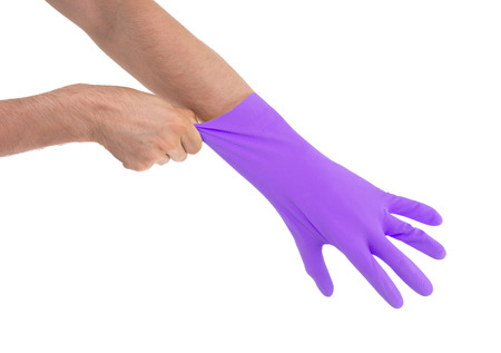 Hand in purple glove - isolated on white backgroundの写真素材