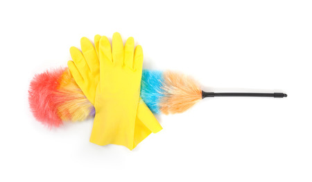 Yellow cleaning gloves with a duster - isolated on whiteの写真素材