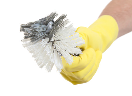 Hand with a protection glove holding a dish-brush