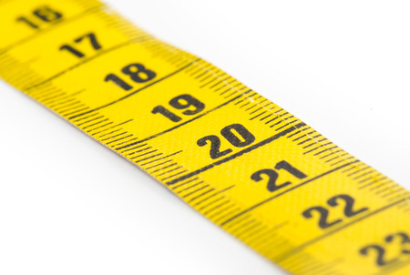 Yellow measuring tape isolated on white background  - selective focusの写真素材