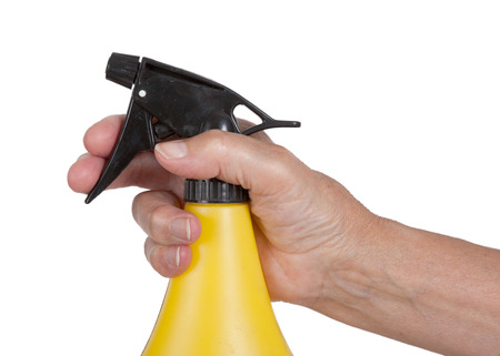 Sprayer in the hand of an old woman, isolated on white