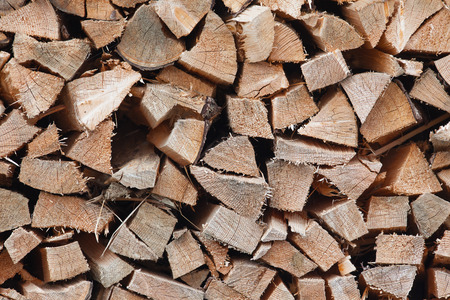 Dry chopped firewood logs ready for winterの写真素材