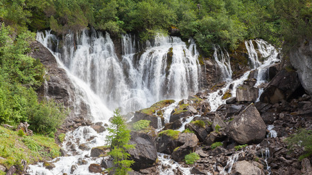 Waterfall in the forest, raging water in Switzerland