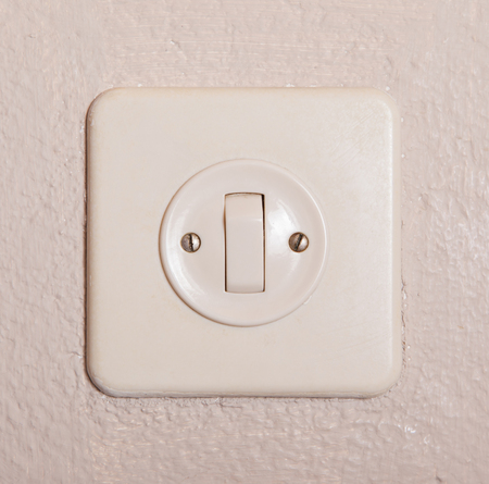 Press turn on/off electrical switch, old plaster wallの写真素材