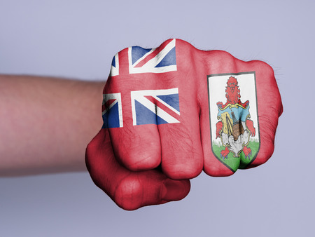 Very hairy knuckles from the fist of a man punching, flag of Bermudaの写真素材
