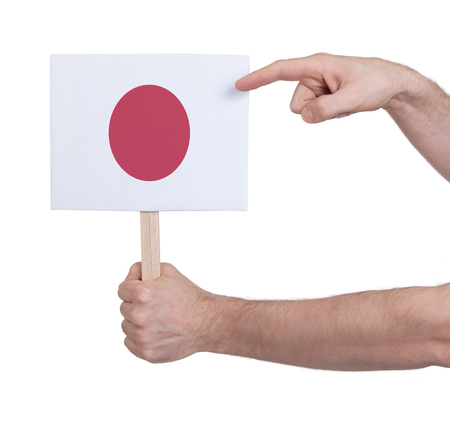 Hand holding small card, isolated on white - Flag of Japanの写真素材