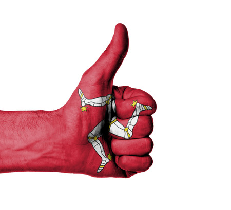 Closeup of male hand showing thumbs up sign, flag of Isle of Manの写真素材