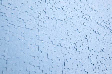 Connected blue puzzle pieces isolated, dirty and usedの写真素材