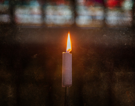 Candle burning inside an old Catholic church - Vintage dirty lookの写真素材