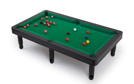 Miniature billiard table on a white background