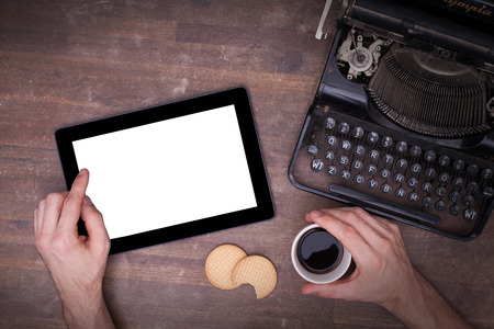 Tablet touch computer gadget on wooden table, vintage look